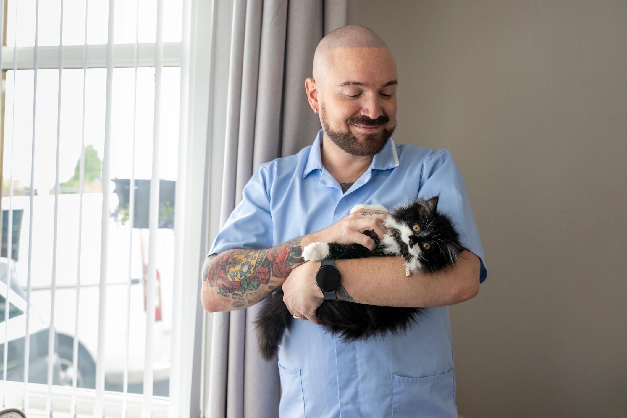 Caregiver holding a cat during a home visit